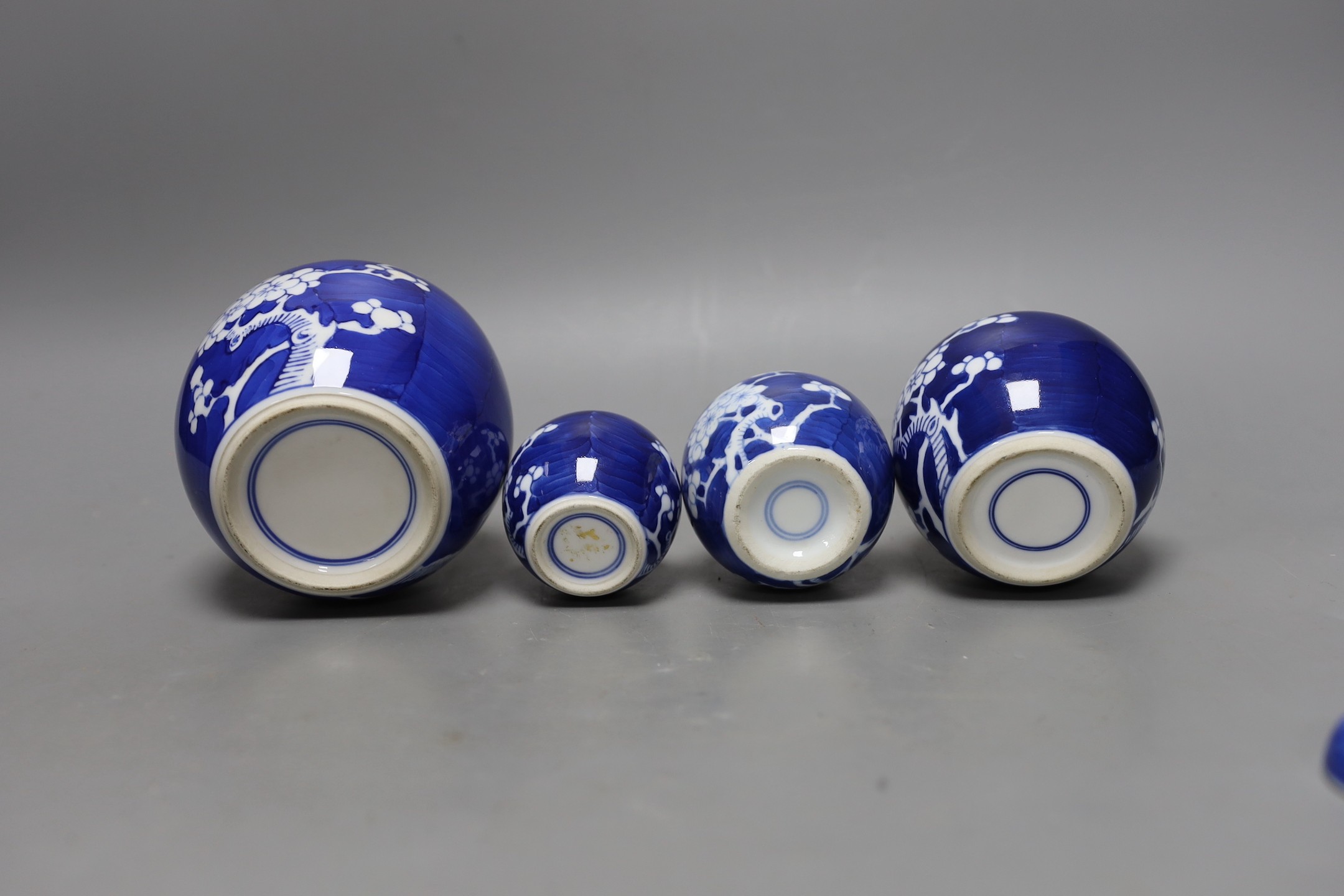 A Chinese bronze hand warmer and four Chinese blue and white Prunus jars and covers. Tallest 12cm